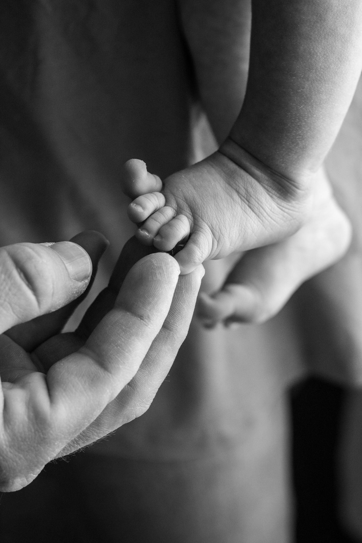 Series of black and white close-up photographs showing interlinked hands.
