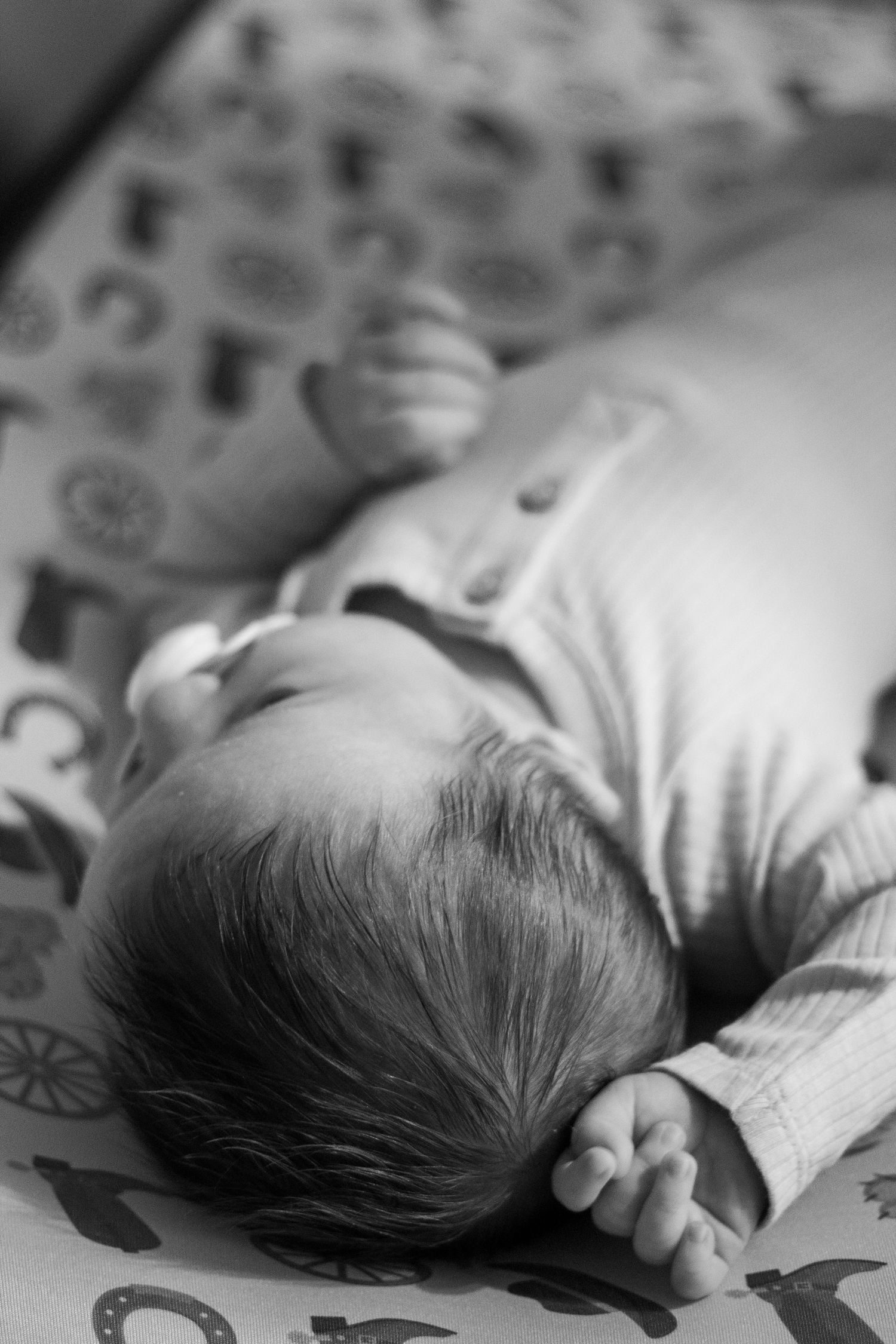 Black and white close-up series of a sleeping newborn baby.