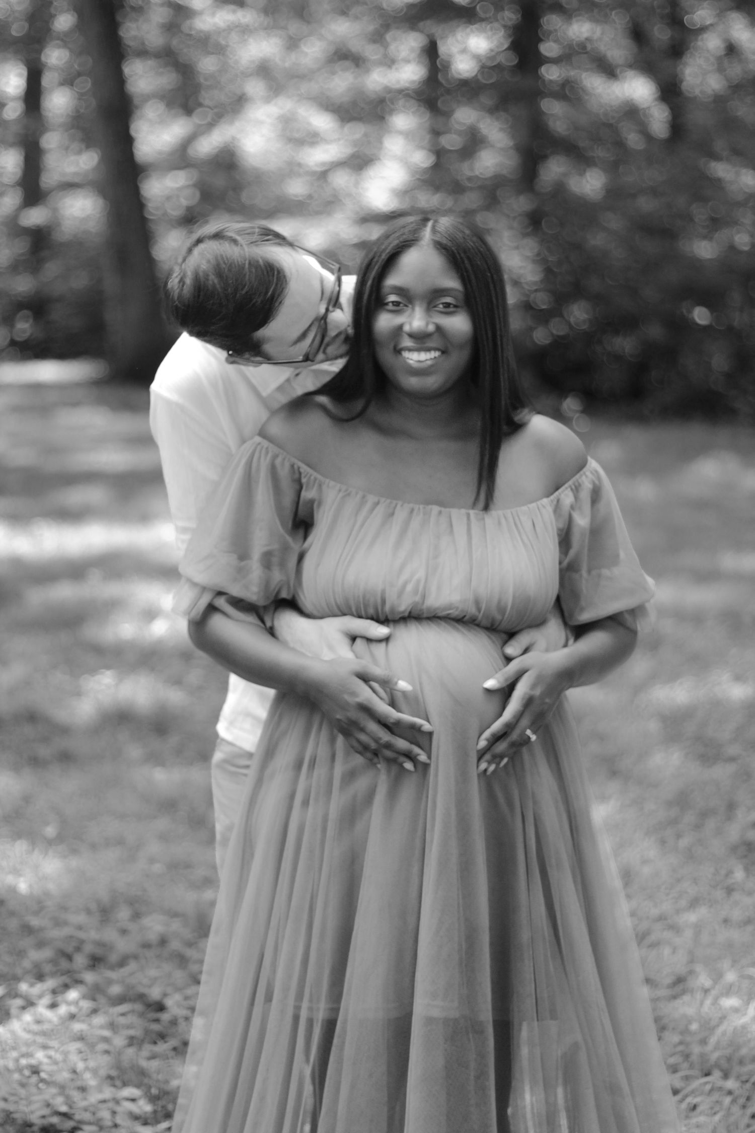 Joyful maternity photo session in a natural outdoor setting.