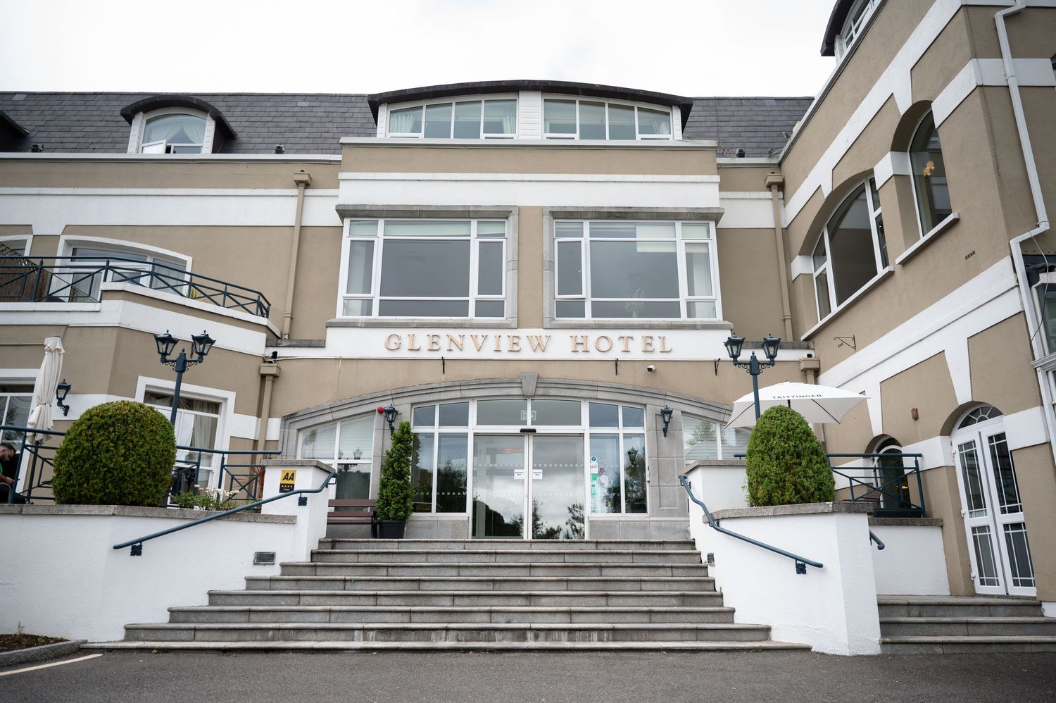 Elegant facade of the Glenview Hotel featuring grand white staircases and classic architecture.