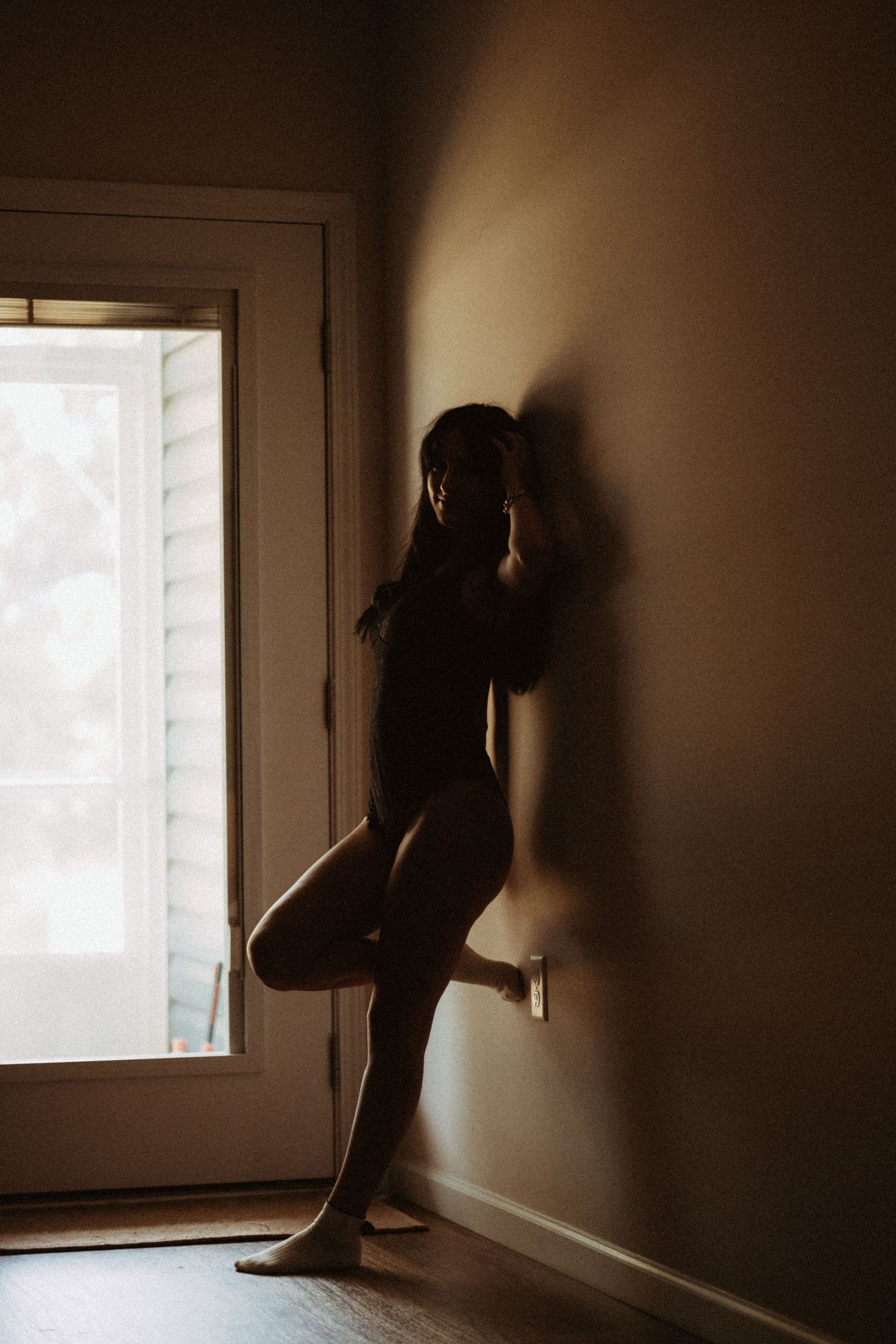 Dramatic silhouette photos showing a figure in shadow against bright window light.