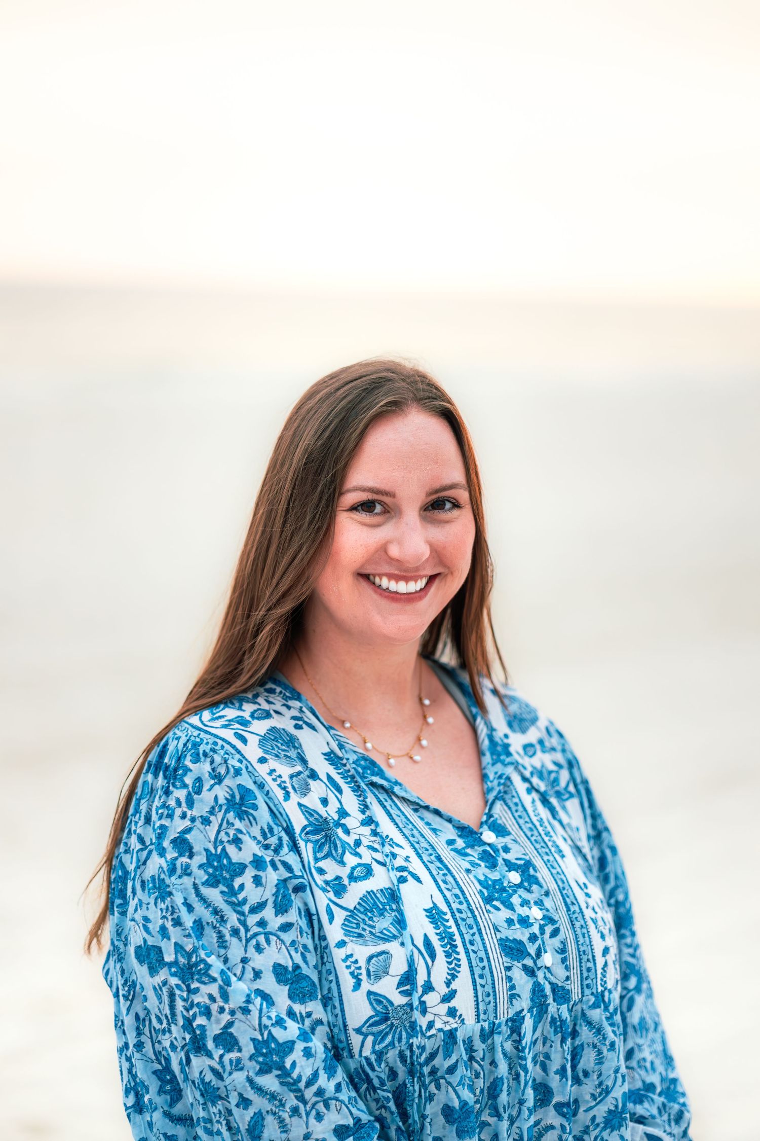 A person wearing a blue and white floral dress poses outdoors with a bright smile in multiple shots.