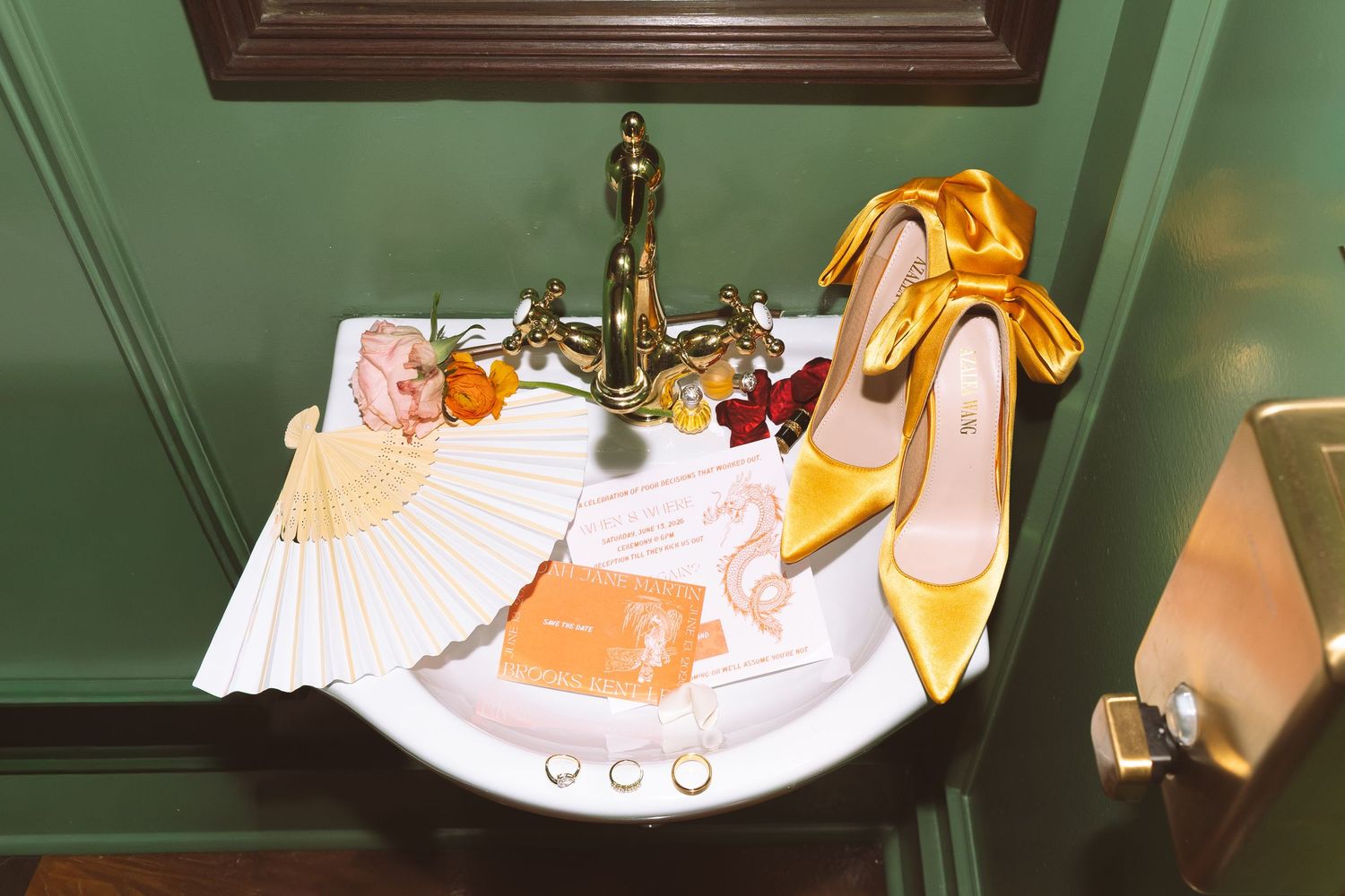 Yellow bridal heels and accessories arranged in vintage green bathroom sink.