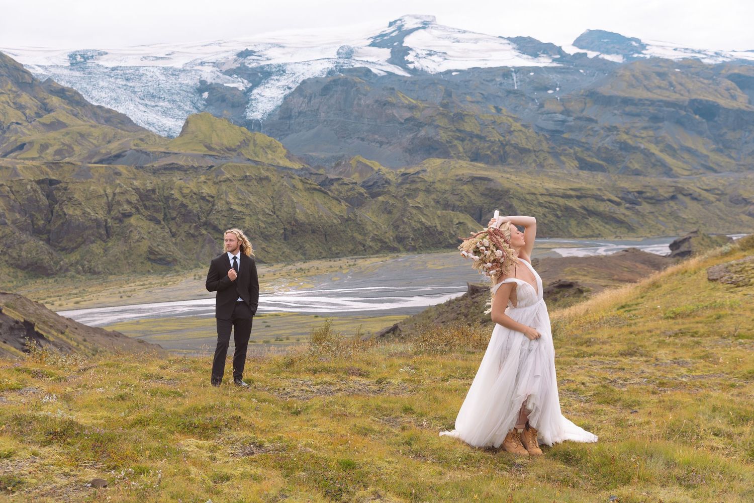 Couple sharing a first look moment during their Iceland elopement wedding with glacier and mountains backdrop.