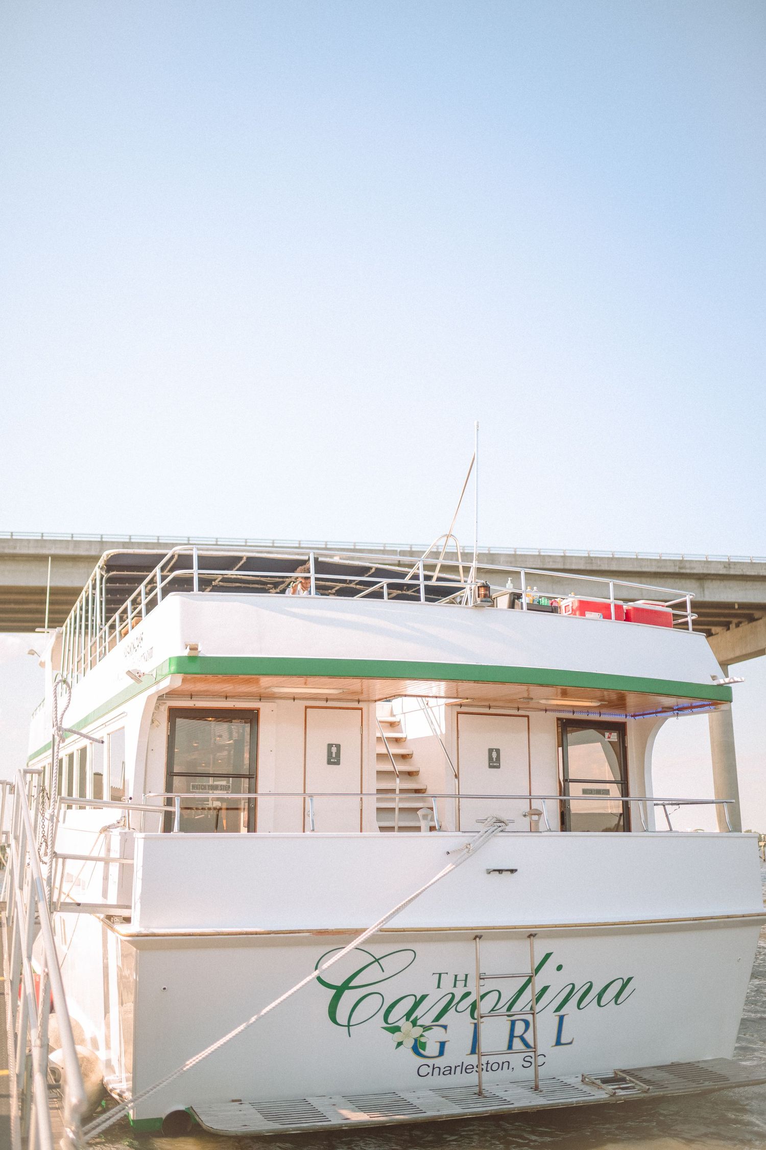 The Carolina Girl charter boat docked in Charleston, SC on a clear sunny day.