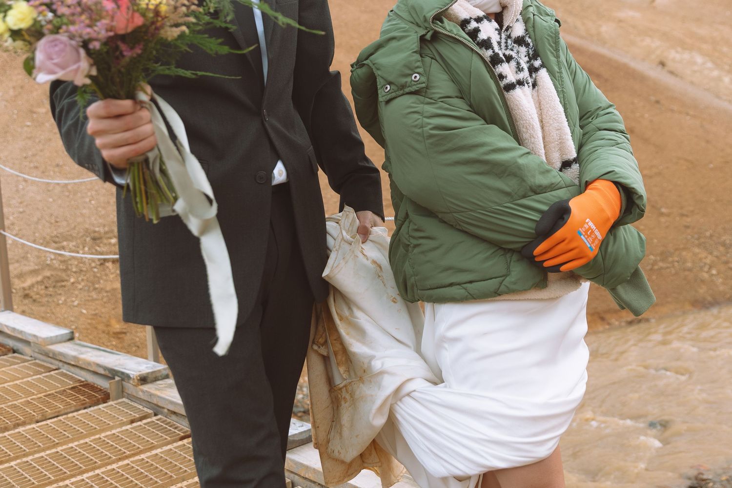 Bride and groom walk together in windy conditions at a dramatic Icelandic landscape wedding elopement.