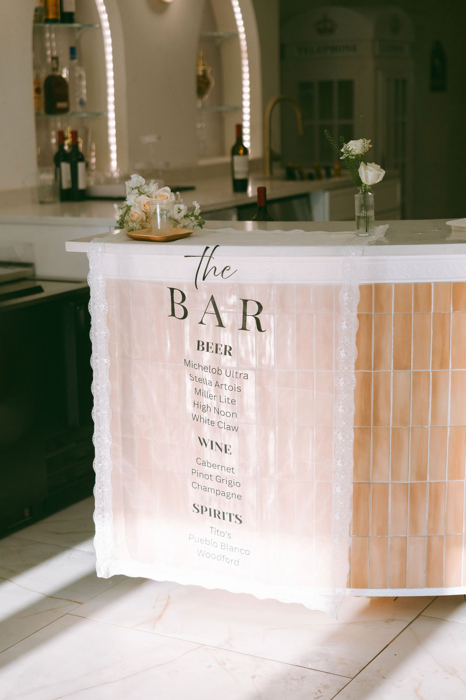 Wedding bar menu sign displaying beer, wine, and spirits selections at a reception.