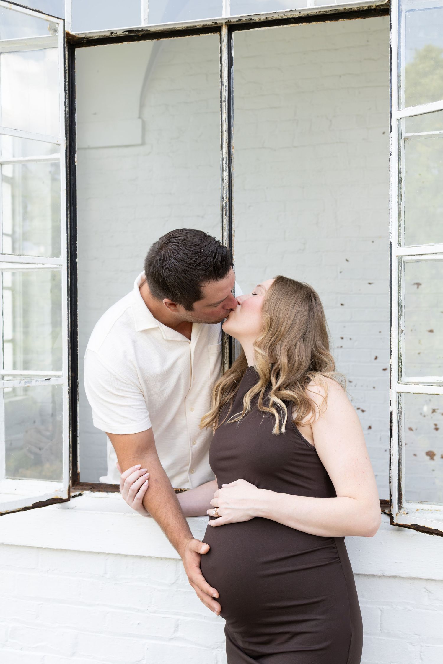 Couple kissing through window