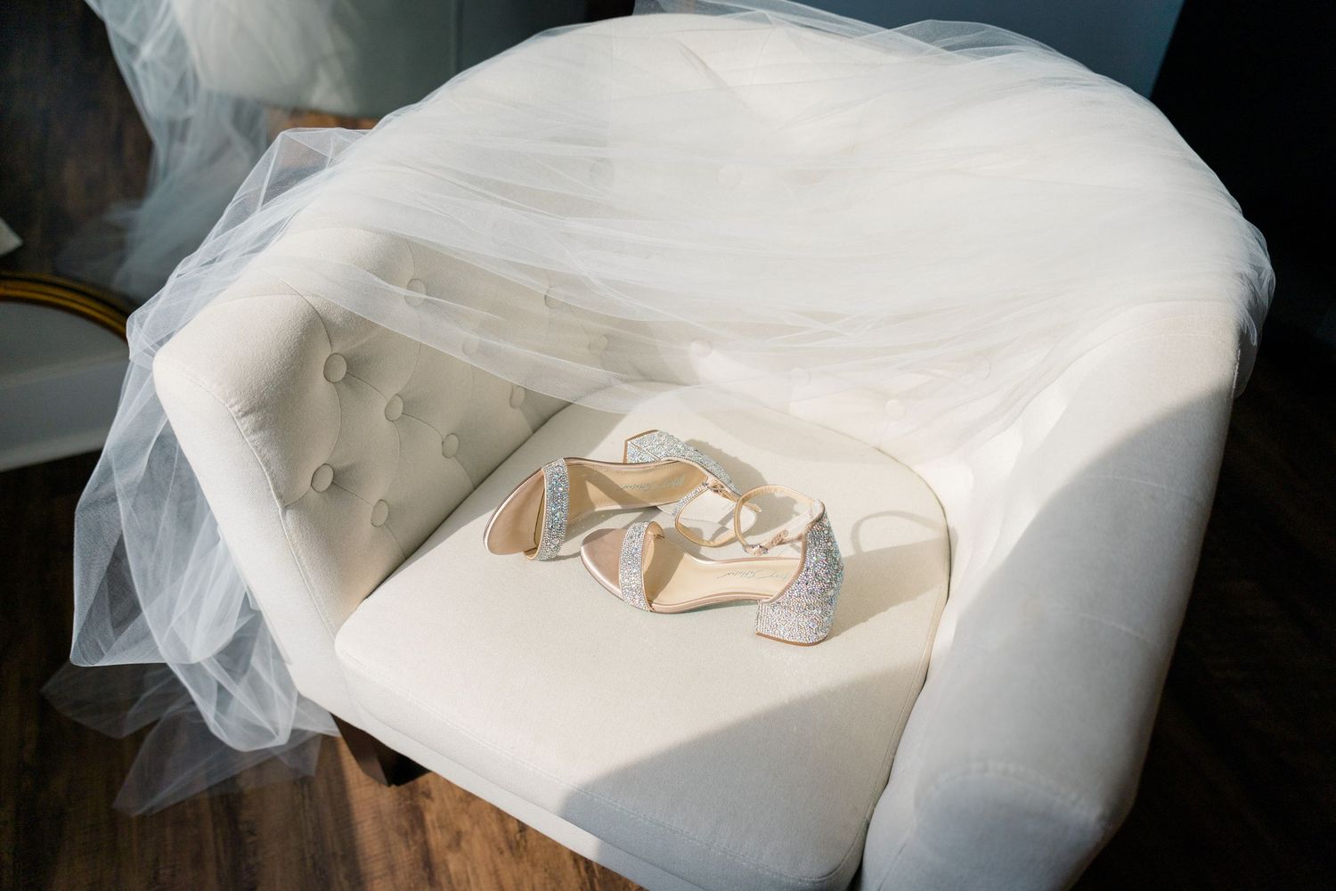 Wedding dress details with delicate tulle fabric in soft natural light.