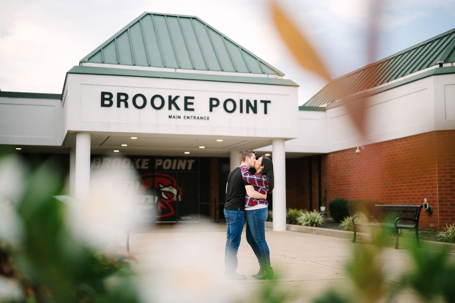 Exterior shots of Brooke Point building entrance with green metal roof and signage.