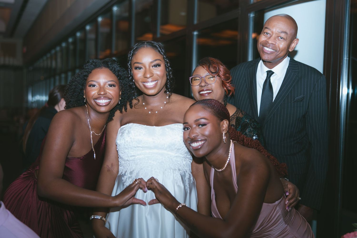 Bride and her family posing at the dinner reception