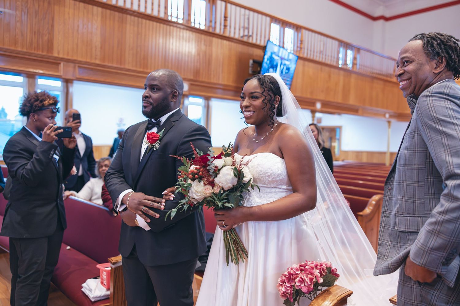 Bride and groom walking down the aisle together at Holy Light Pentecostal Church