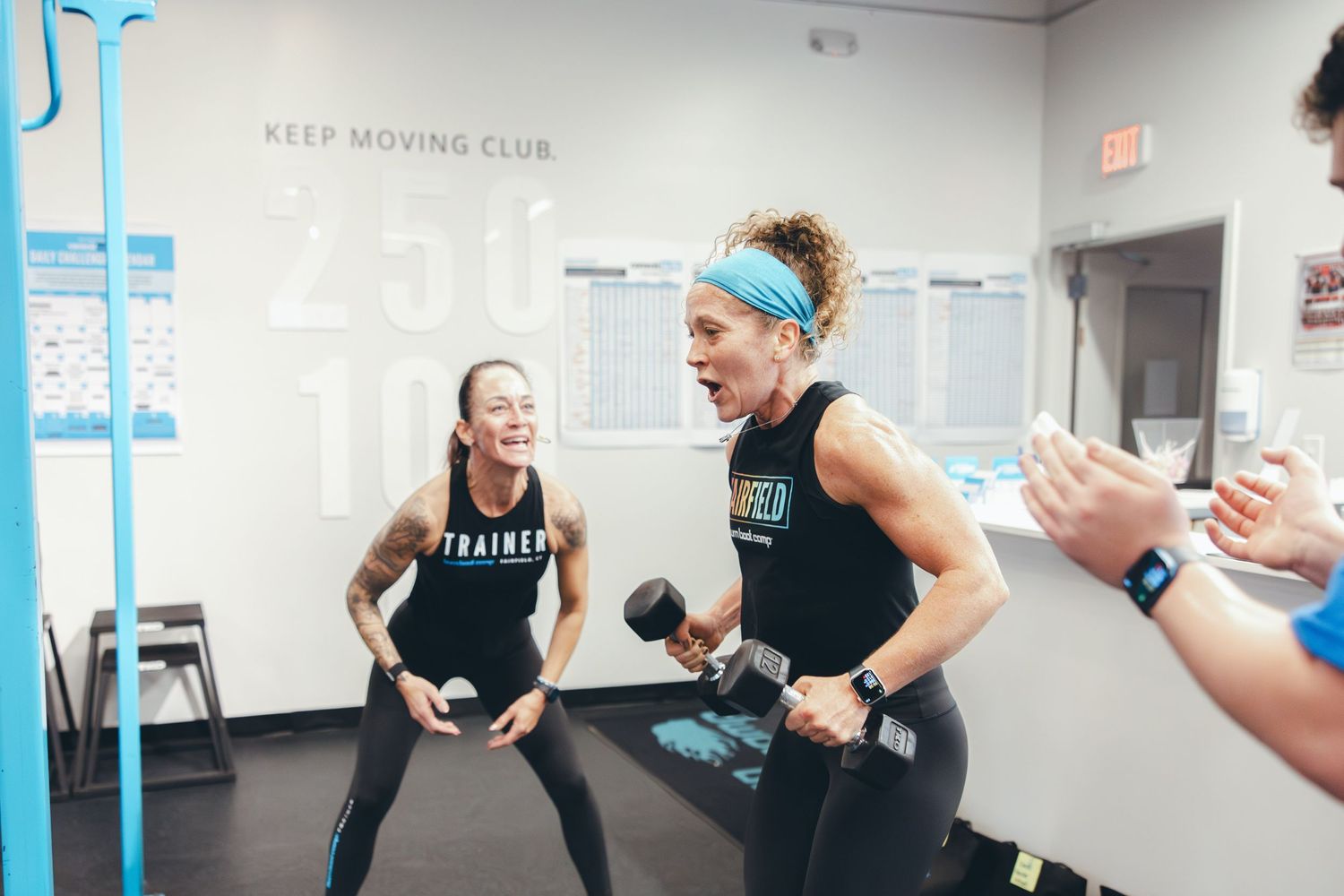 Enthusiastic participants engaging in a dynamic workout session at Keep Moving Club.