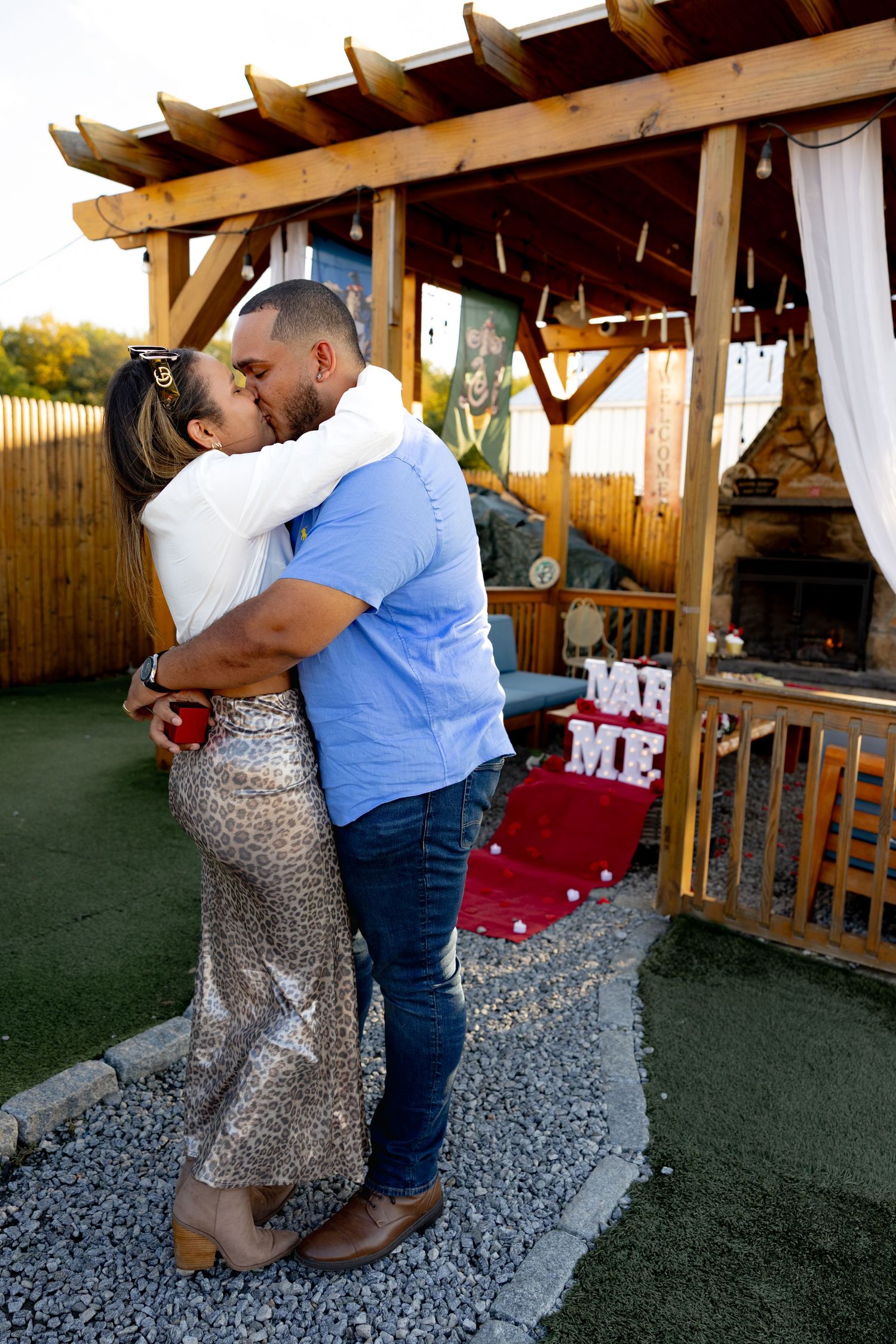 A romantic proposal sequence showing a couple embracing on an outdoor patio.