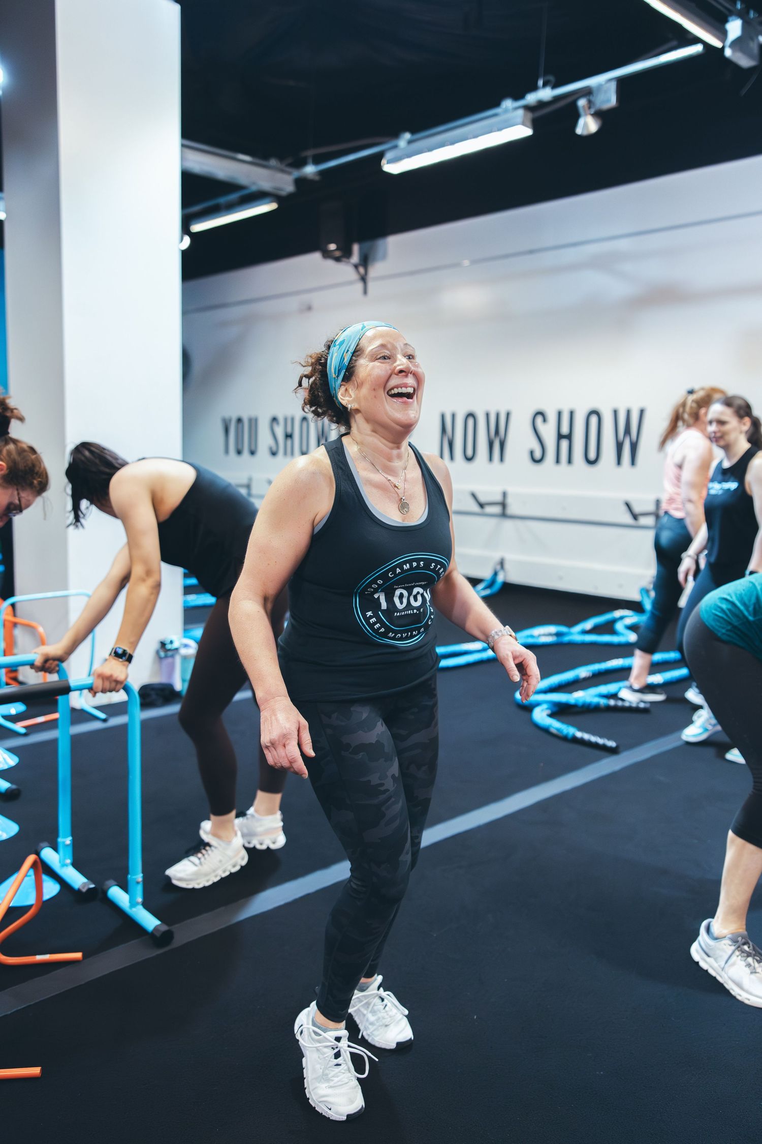 Participants enjoying a lively group workout session in a modern fitness facility.