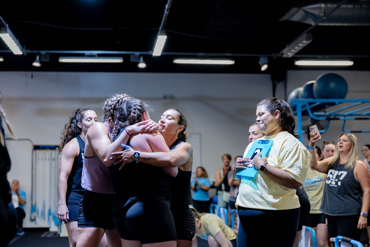 Exercising group participating in an energetic workout session at a fitness studio.