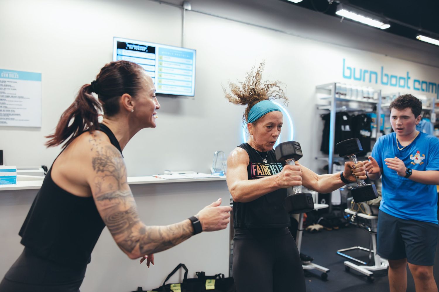 People sharing a fun moment during an energetic fitness class session.