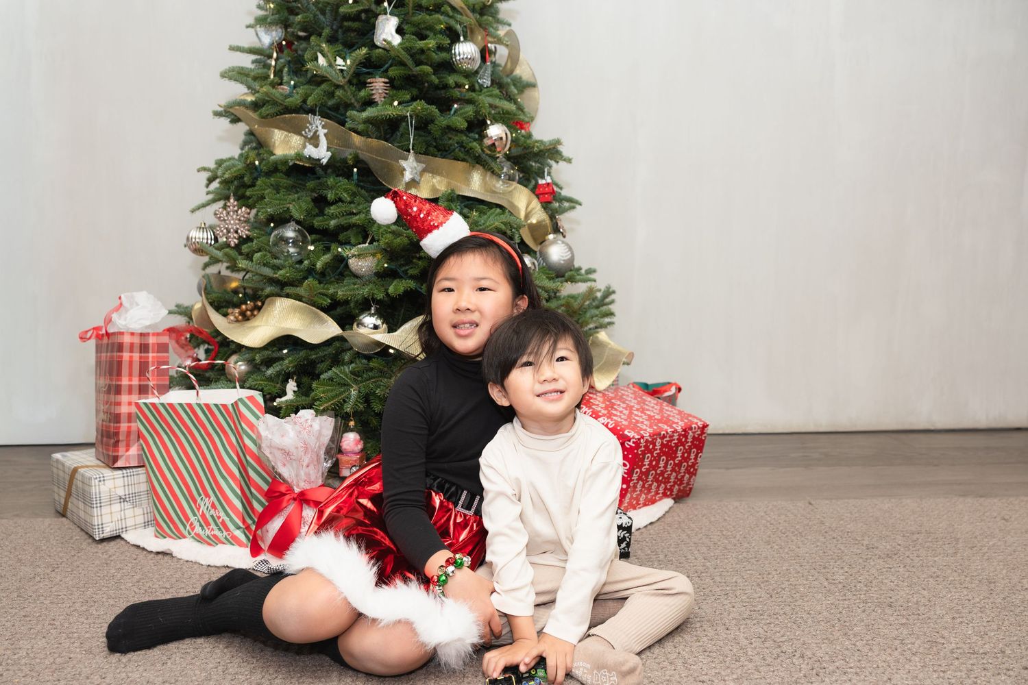 A Christmas photo collage showing a decorated tree with presents and holiday decor.