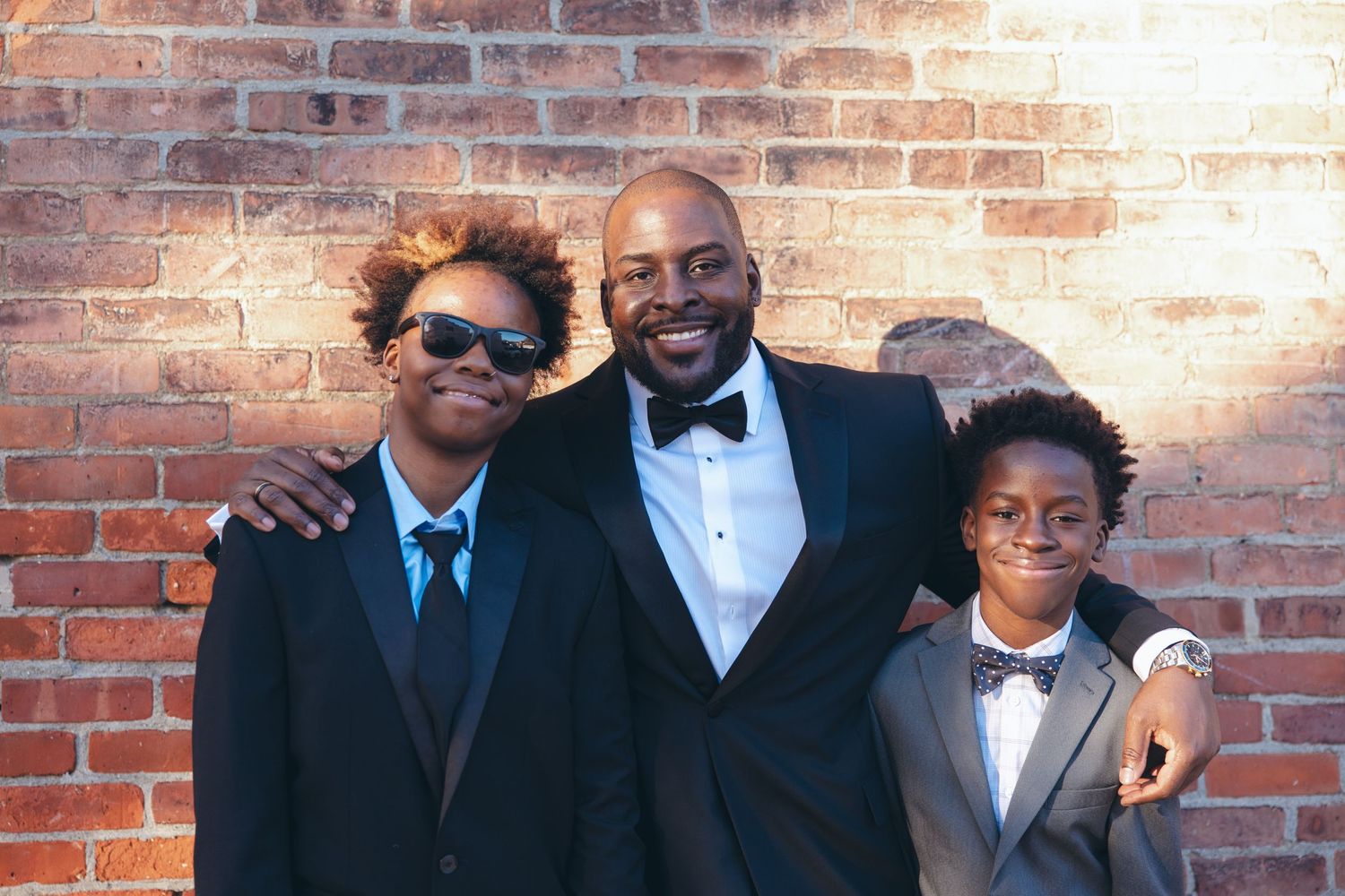 Groom smiling at the camera with his nephews