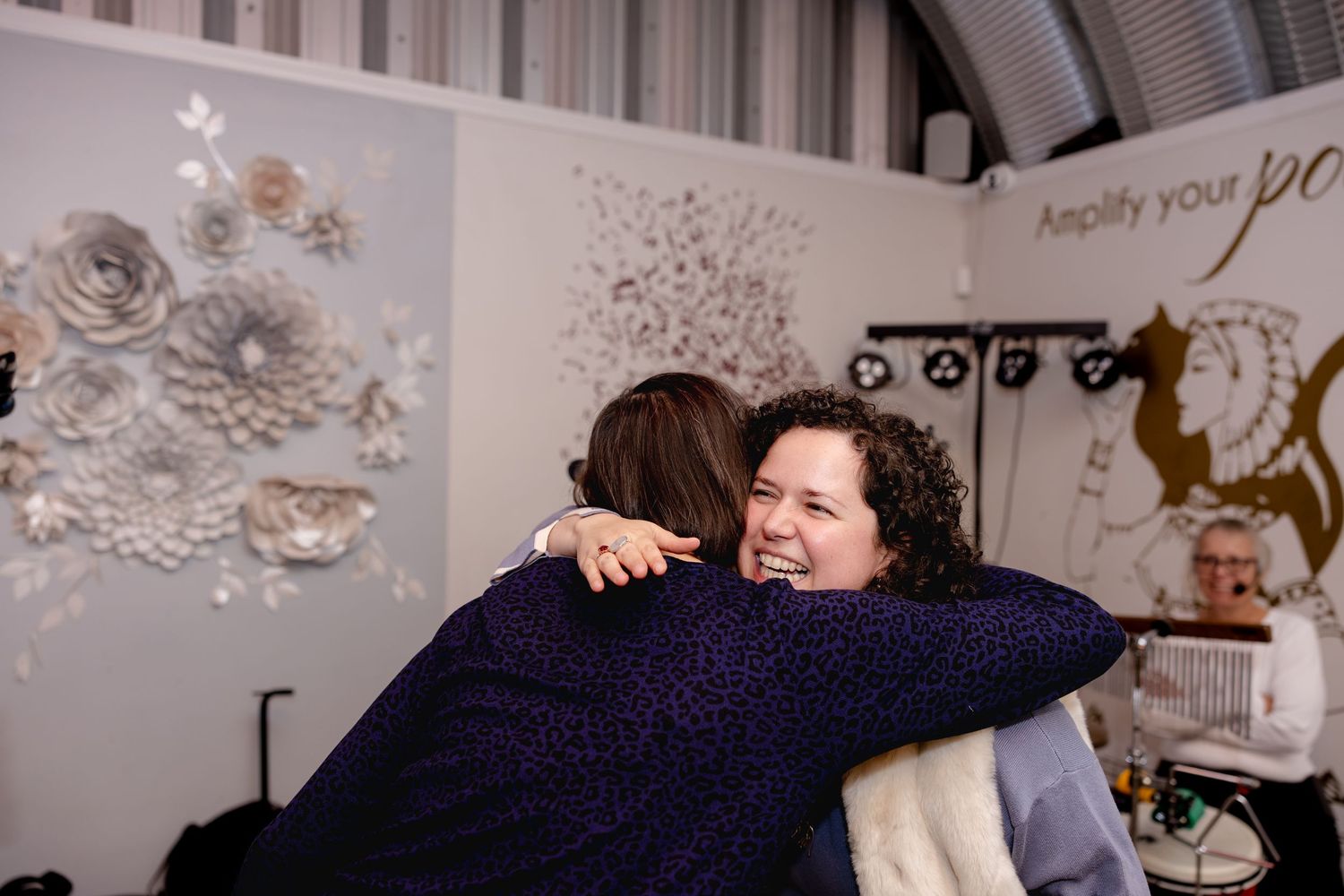 A series of black and white photographs displayed in a gallery showing intimate family moments and interactions.