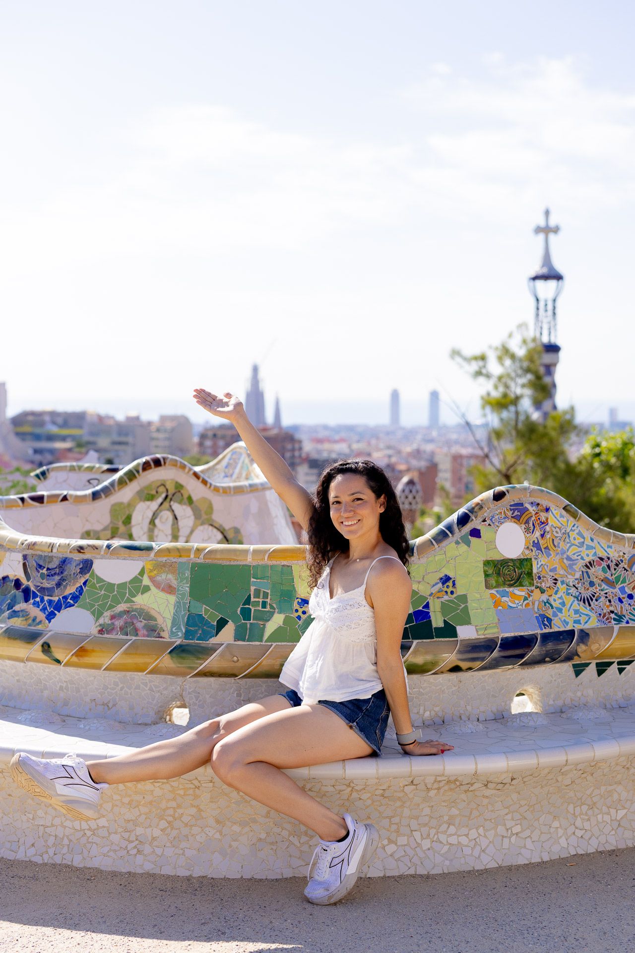 Artistic shots at Park Guell in Barcelona featuring colorful mosaic benches and city views.