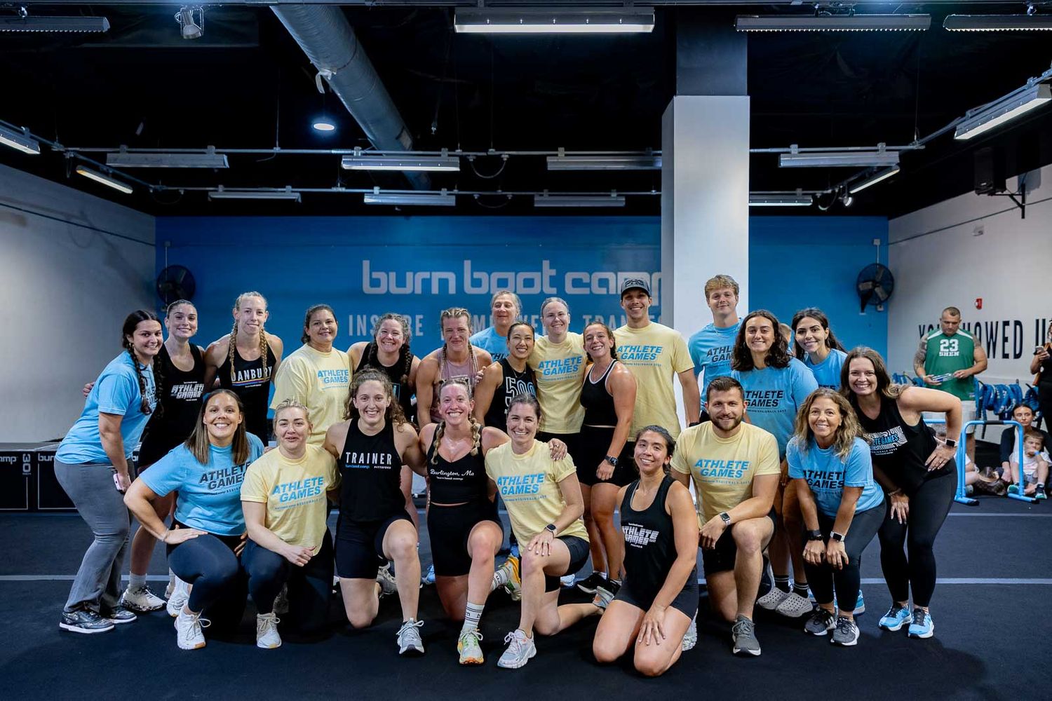 Group photo of workout participants posing together at a Burn Boot Camp fitness center.