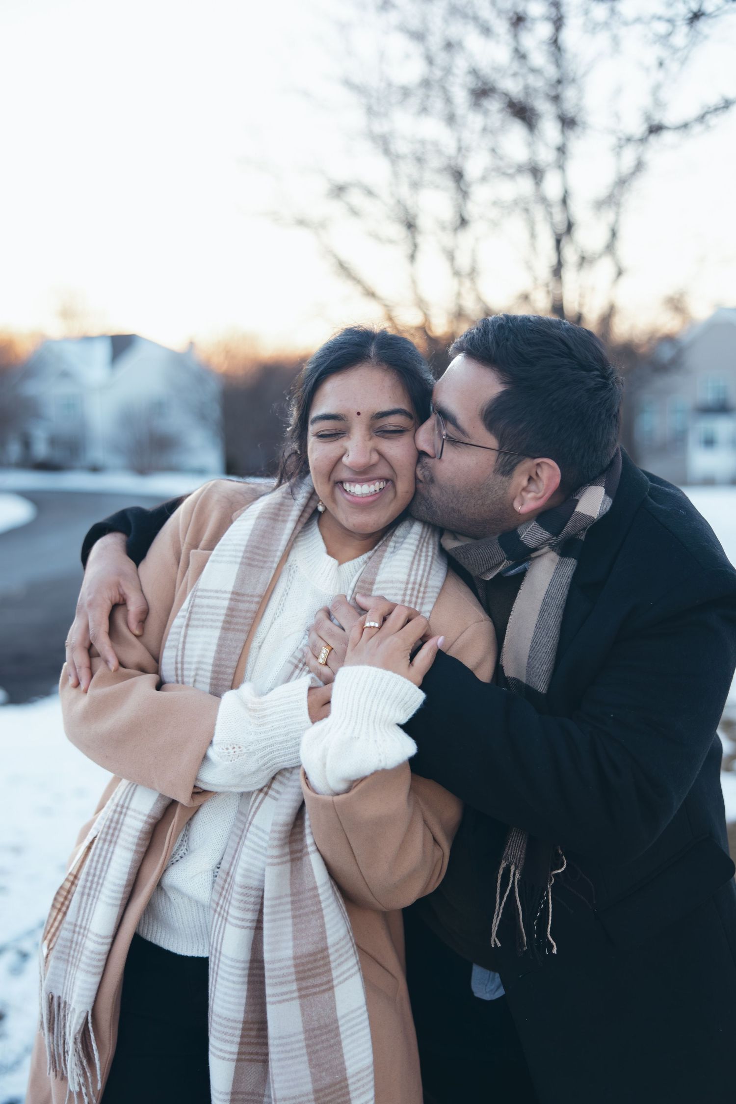 Man kissing his bride to be on the cheek