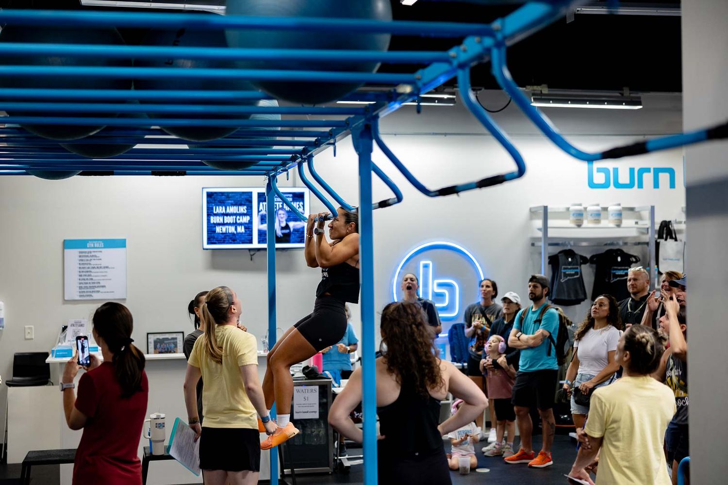 Students participating in group activities and discussions in a modern classroom with blue wall accents.