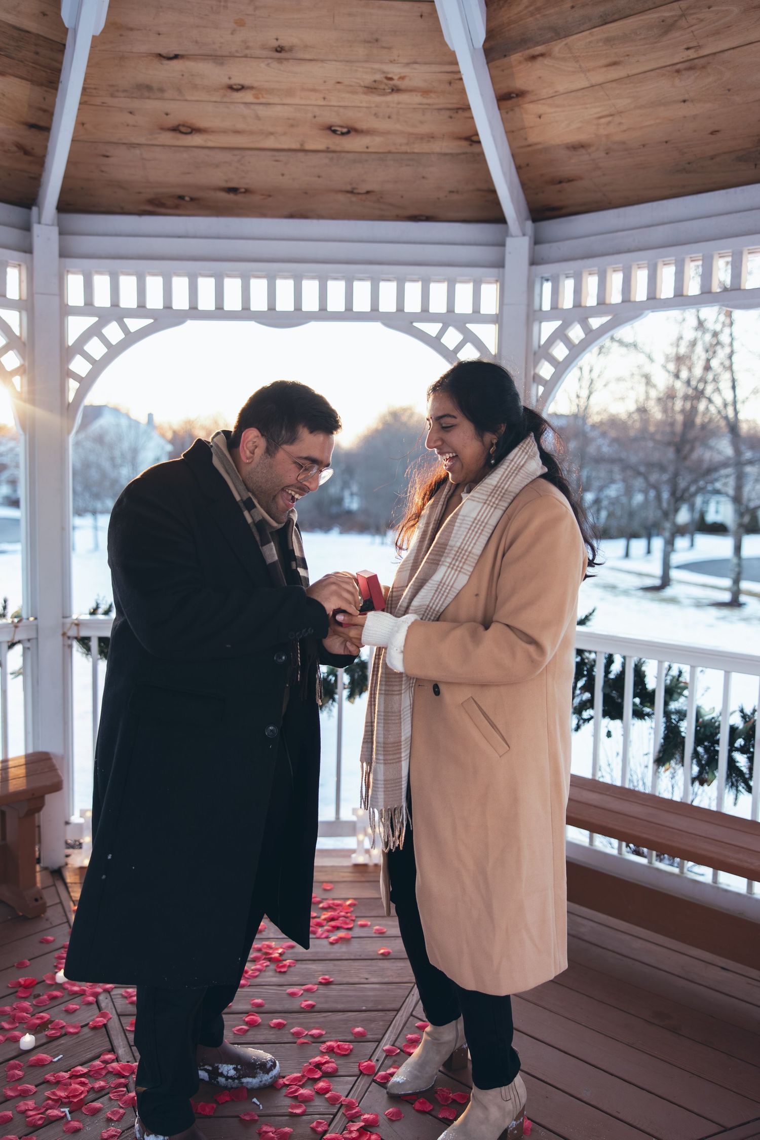 Man putting ring on his bride to be in Southbury CT after surprise proposal