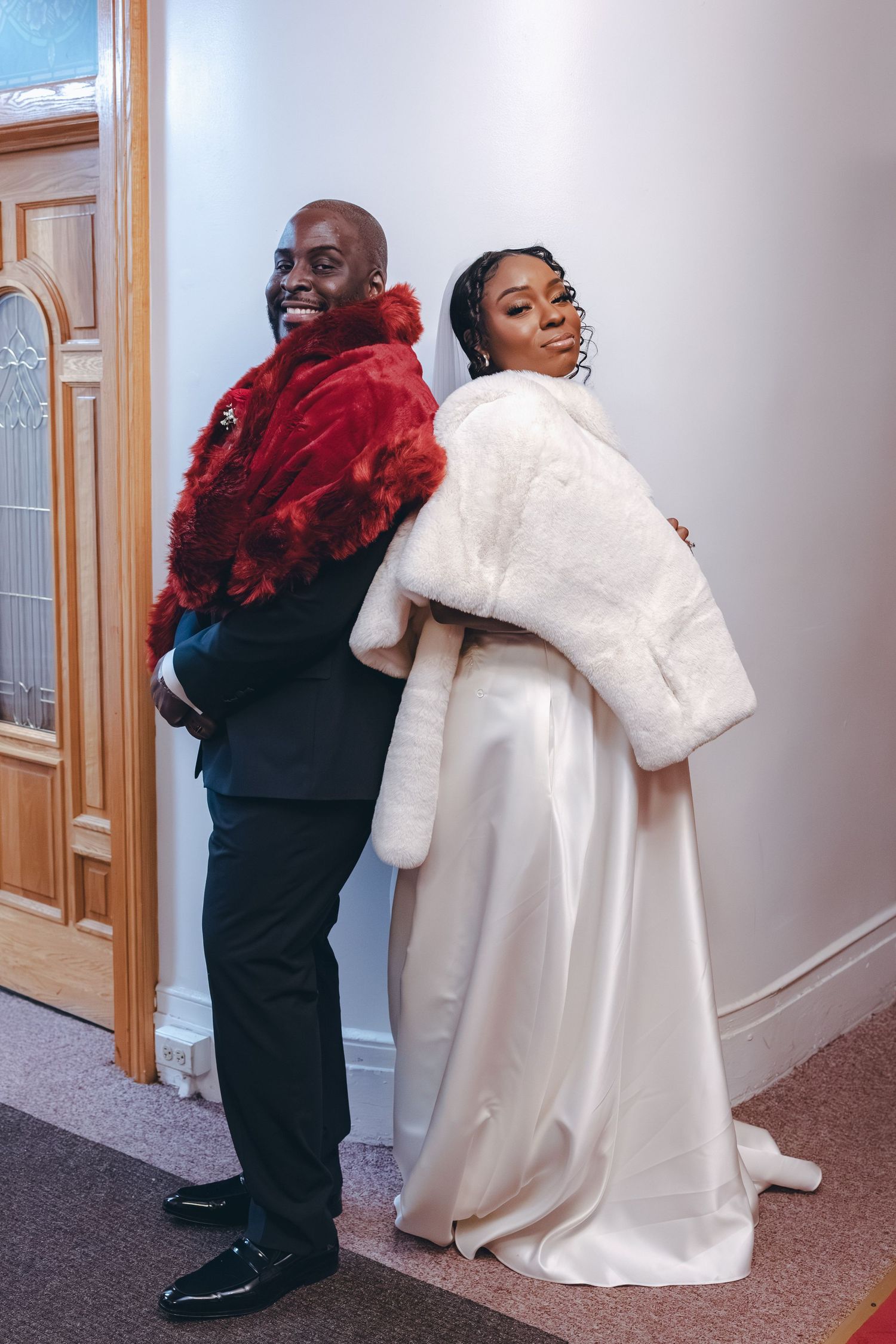 Bride and groom posing back to back