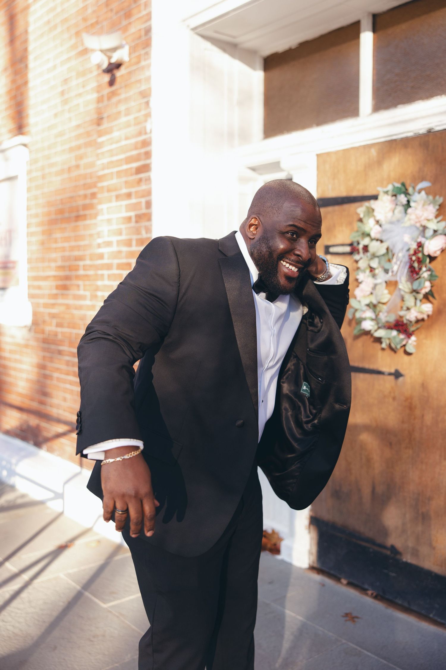 Groom posing in front of Holy Light Pentecostal Church before his Hudson Valley wedding