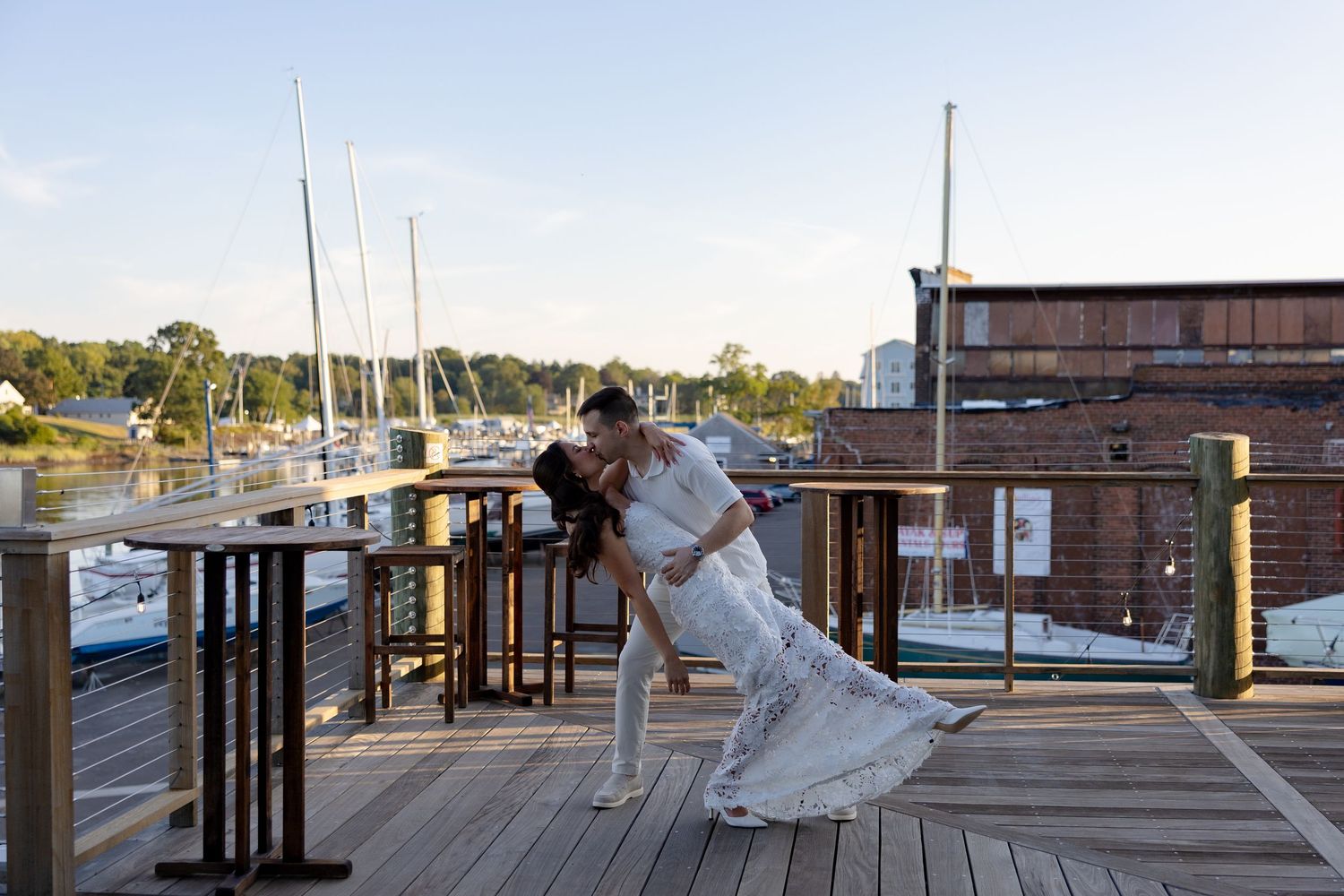 Scenic marina boardwalk wedding photos with boats and docks in the background.