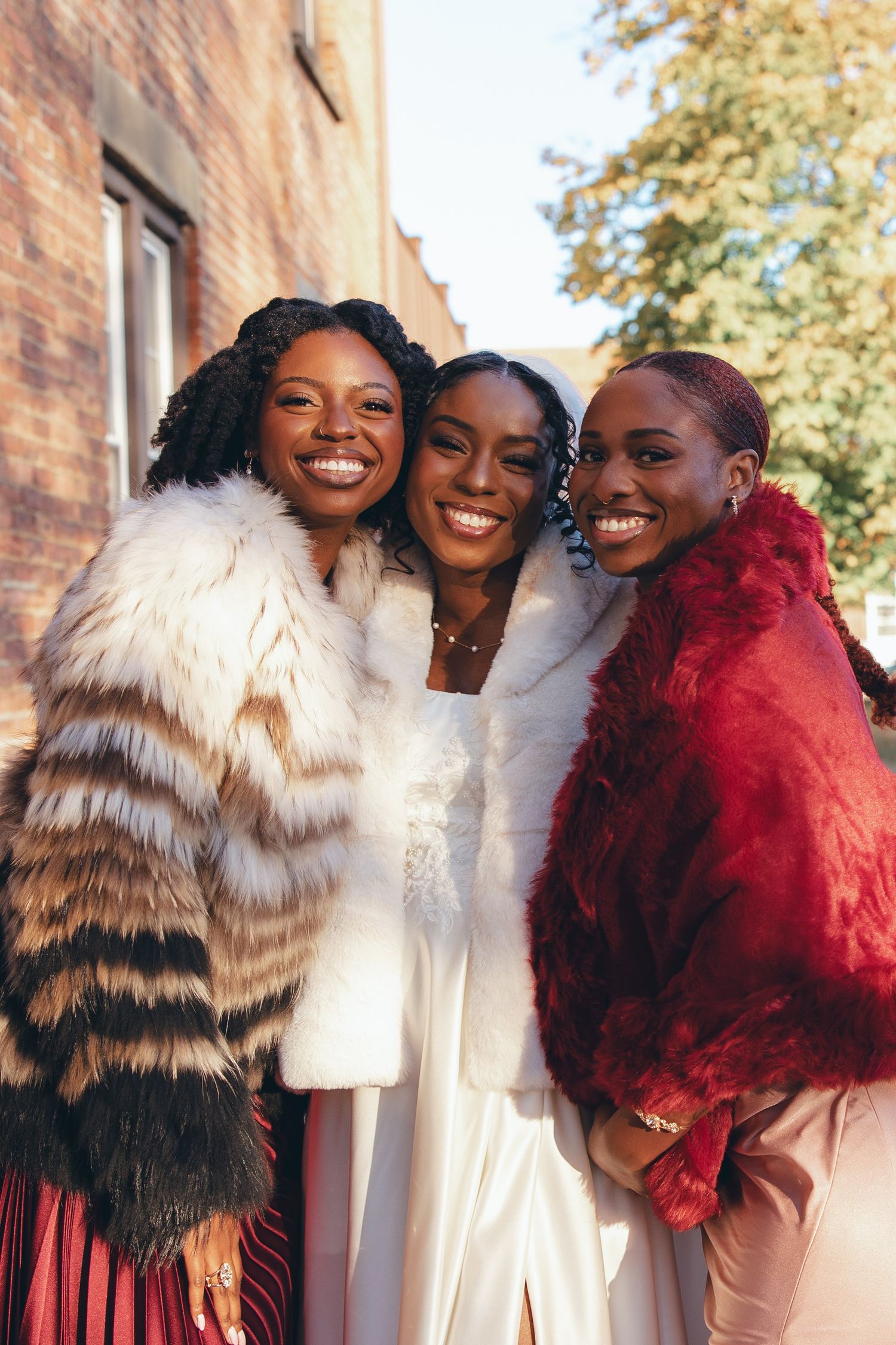 Bride with her sisters smiling at the camera
