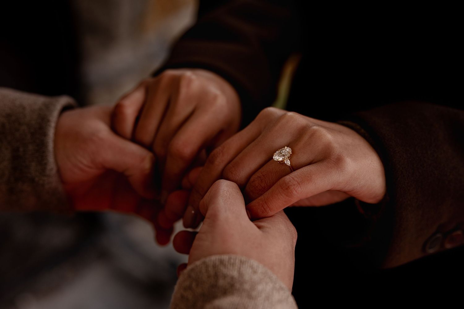 Close-up sequence of hands exchanging wedding rings during a romantic ceremony.