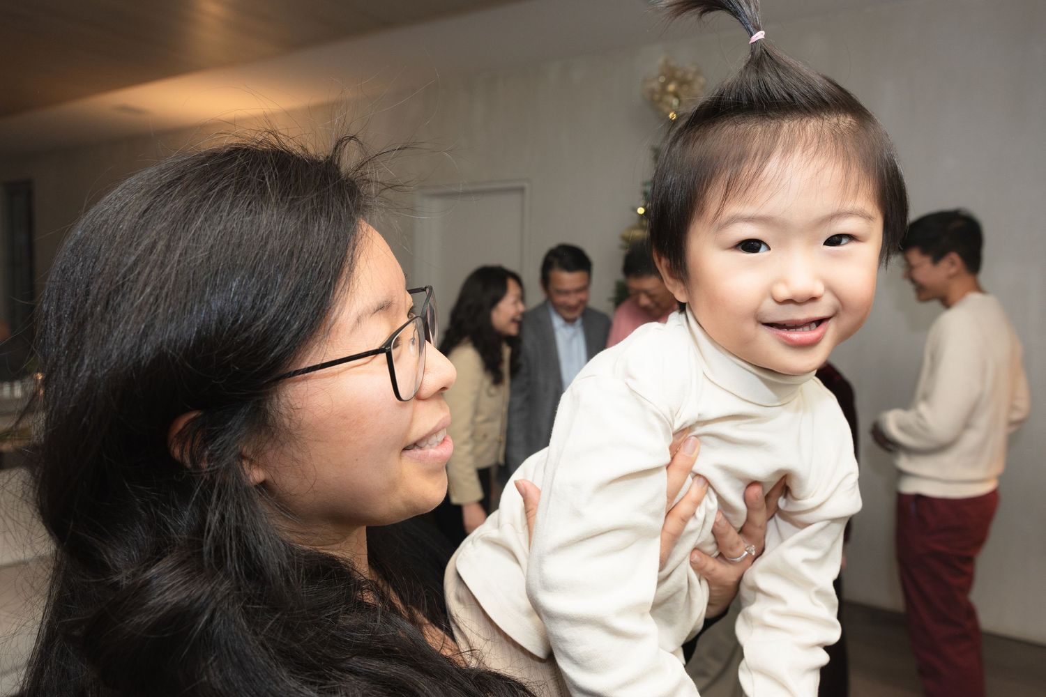A sequence of candid photos shows tender interactions between a parent and young child in casual indoor settings.