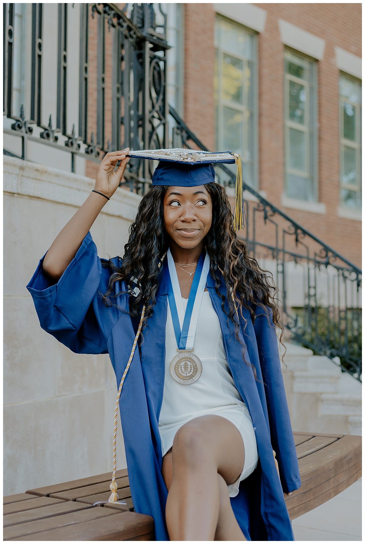 female graduate holding cap and smiling