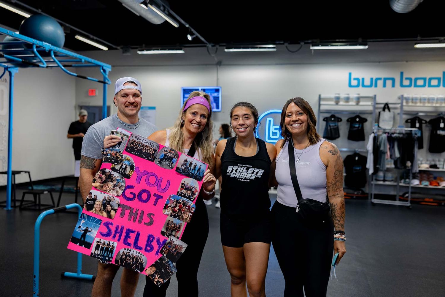 A group of people in a gym exercising by doing planks and high intensity interval training workouts on mats.