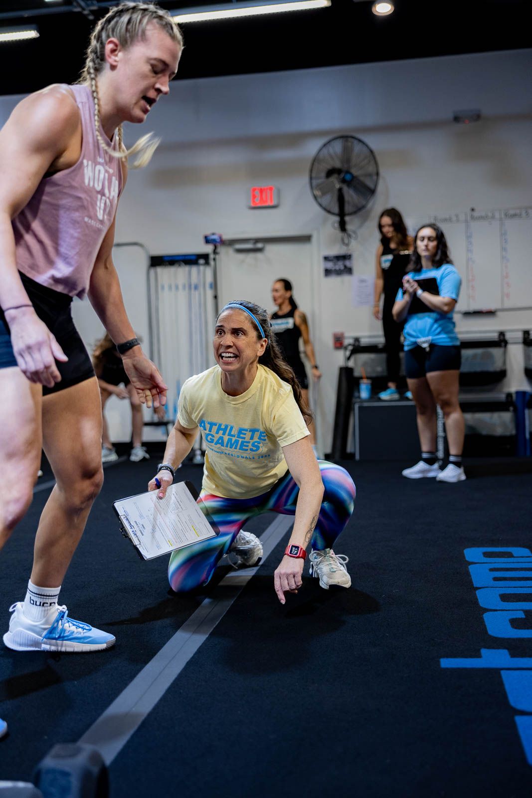 Athletes engaging in a workout session at a fitness facility with athletic gear and equipment visible.