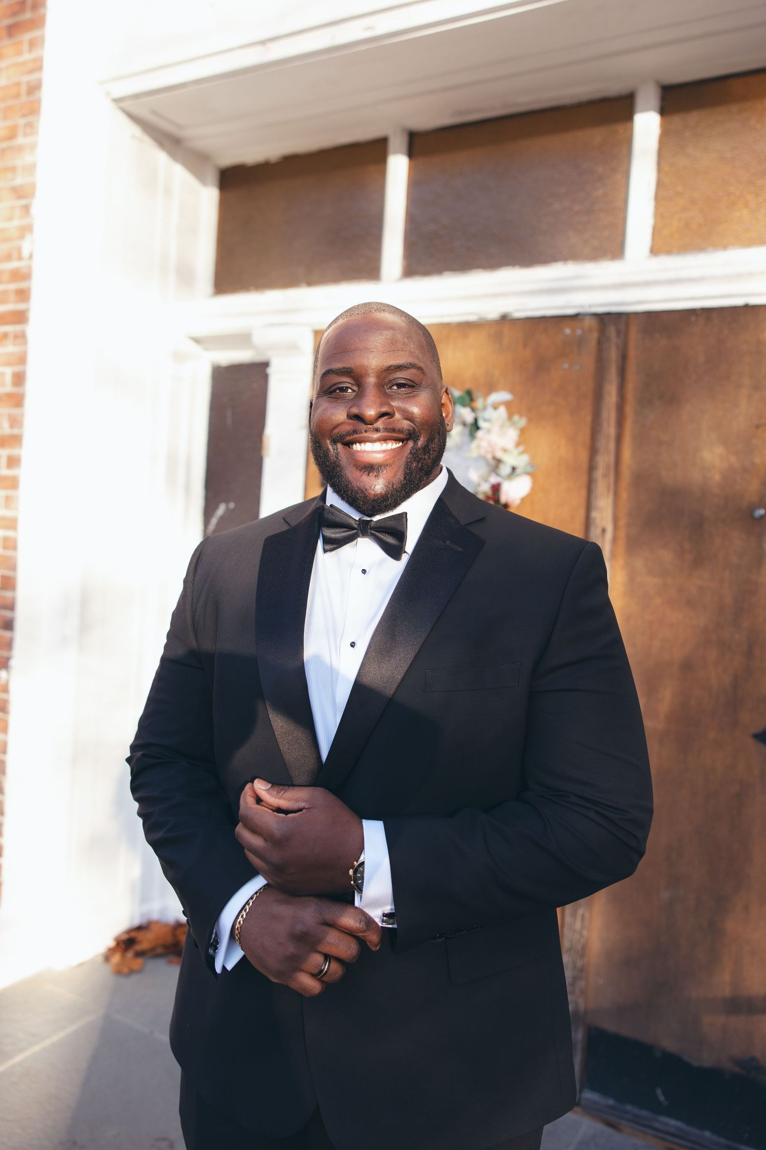Groom smiling at the camera