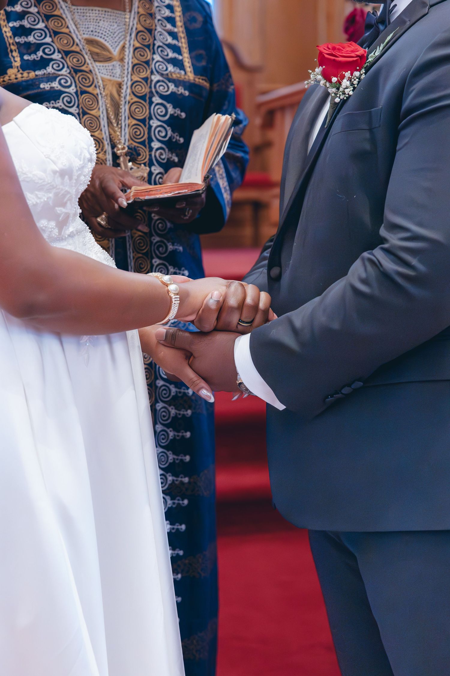 Bride and groom holding hands during the ceremony