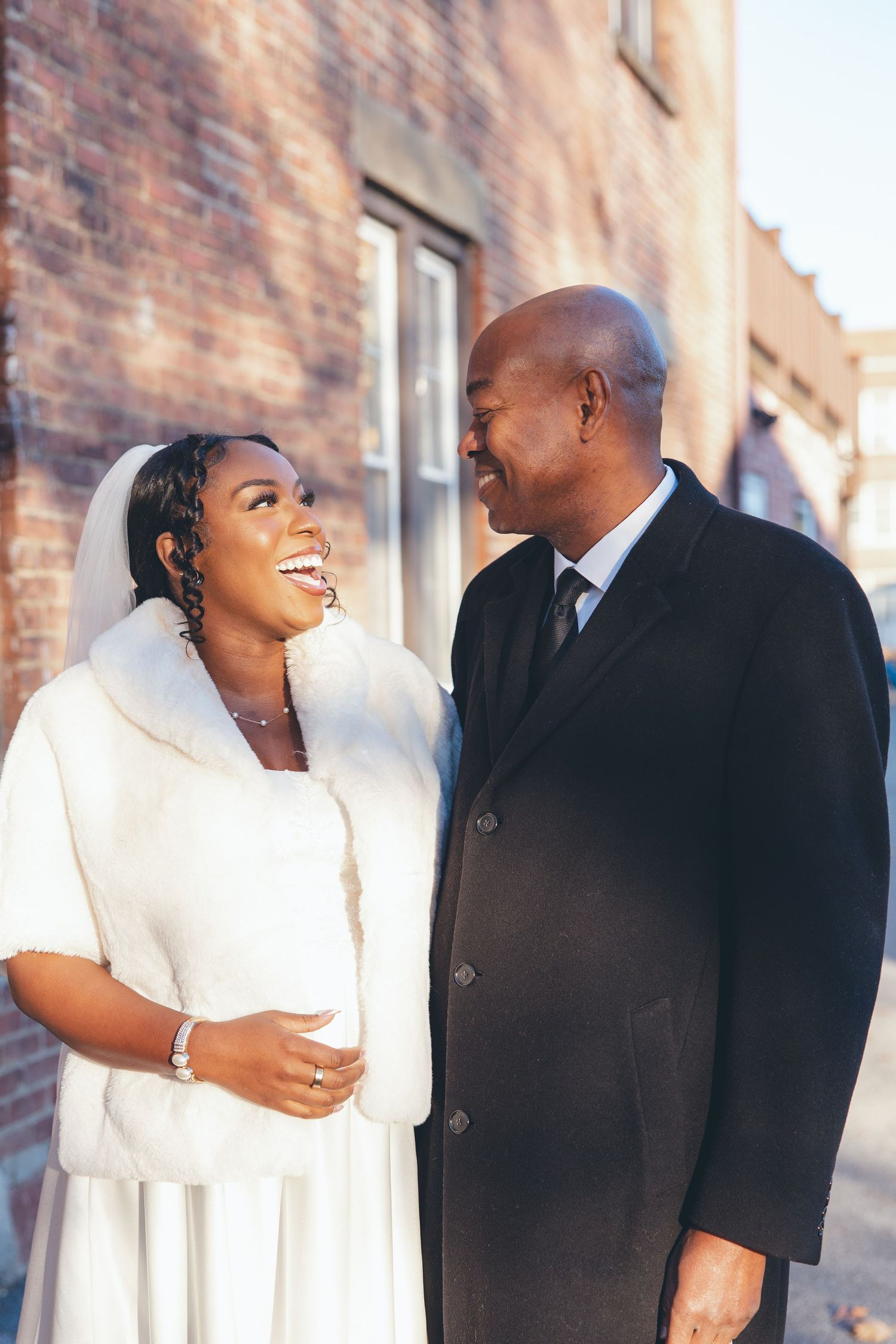 Bride and Father smiling at each other before wedding ceremony