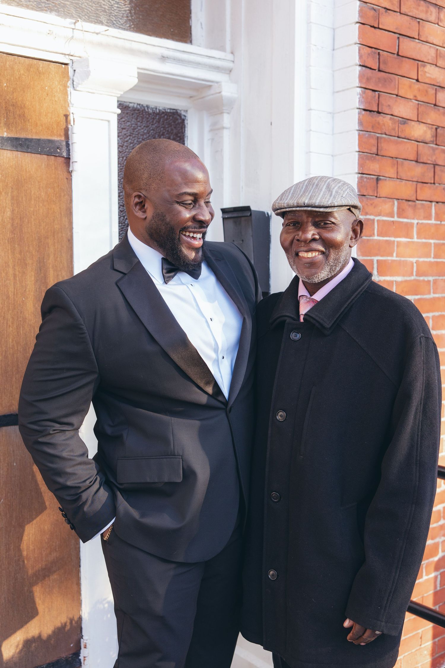 Groom and his father portrait in front of Holy Light Pentecostal Church
