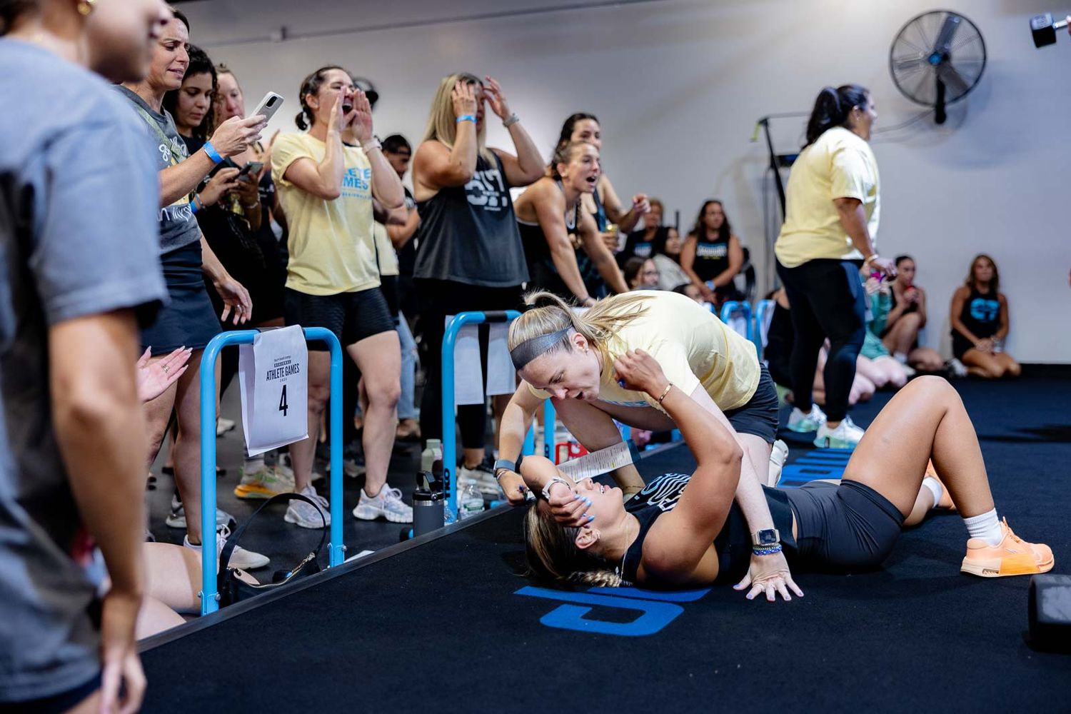 Gym members cheer and react enthusiastically during an intense workout session.