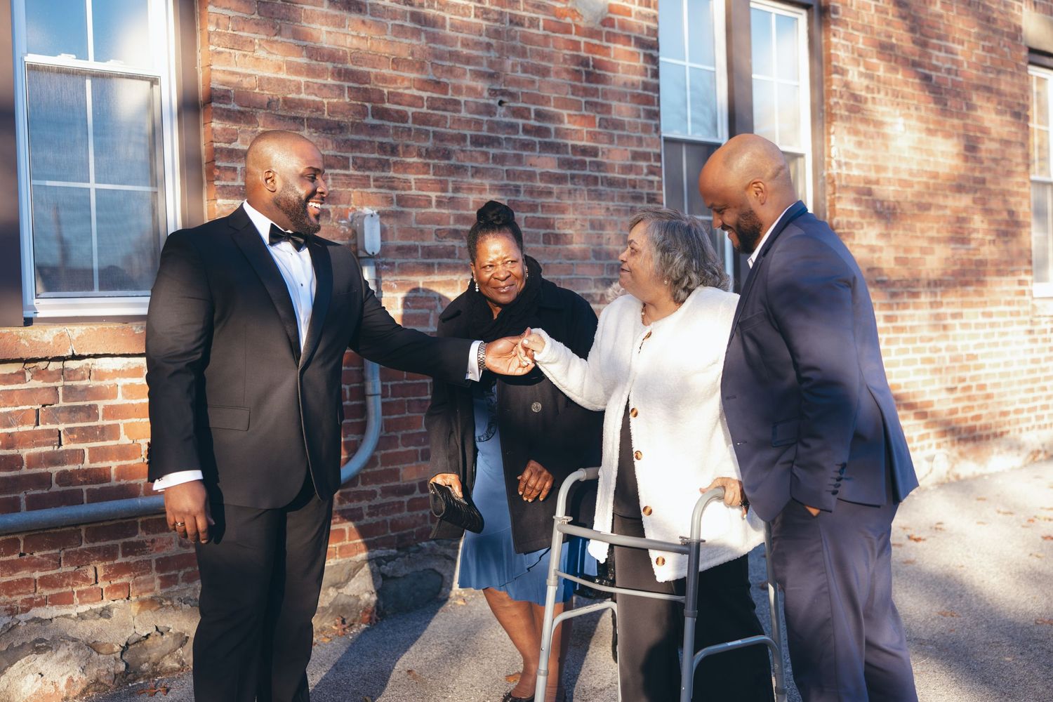 Groom saying hello to his family in front of Holy Light Pentecostal Church