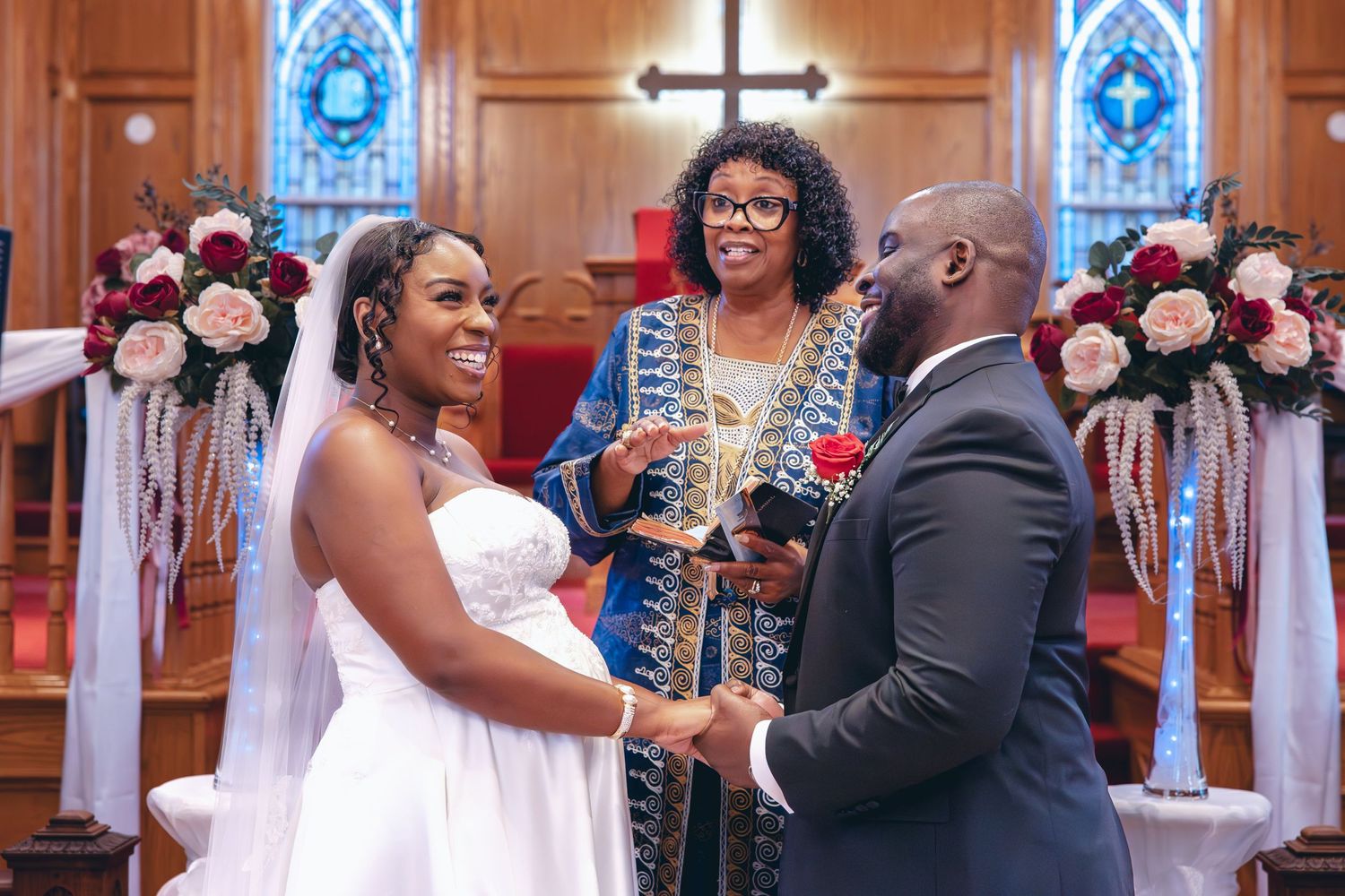 Bride and Groom laughing at the alter