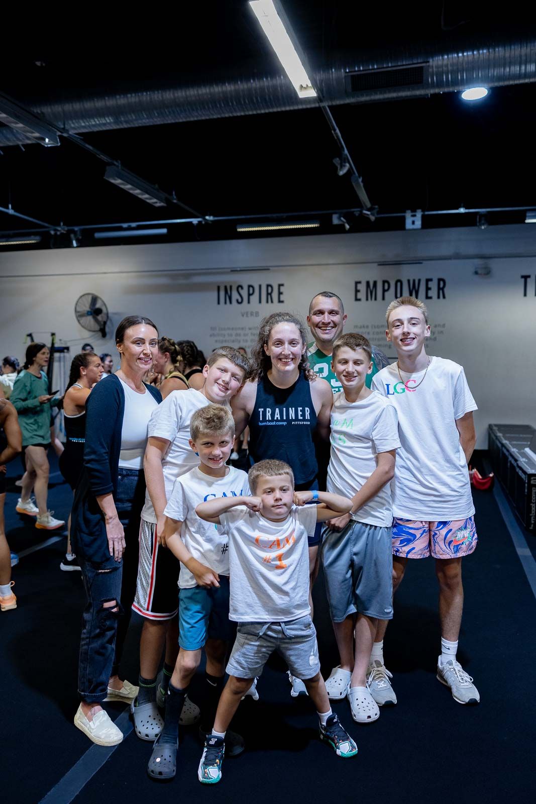 A group poses together in a gym setting with an 