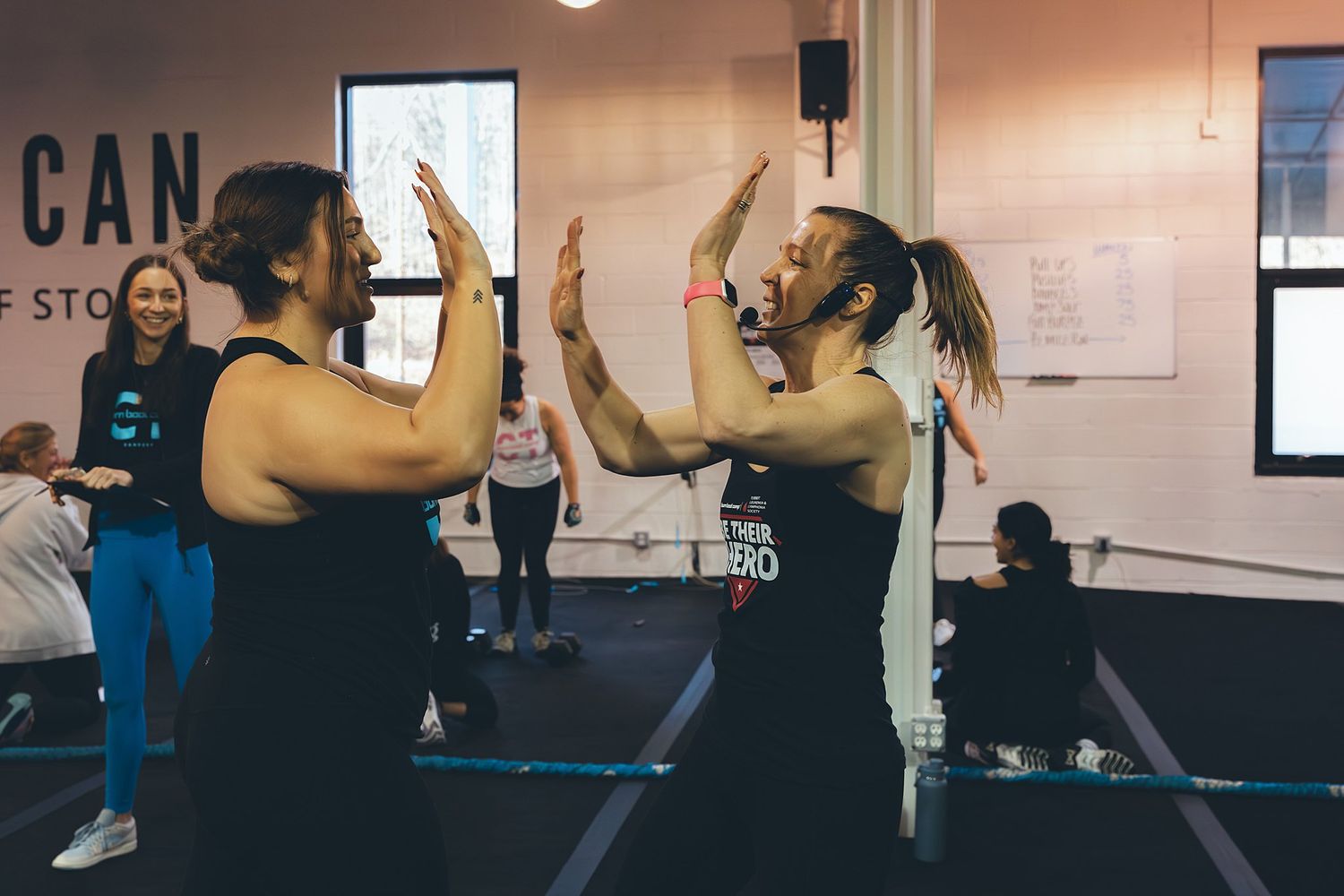 Highfives between BurnBootCamp Trainer and Member