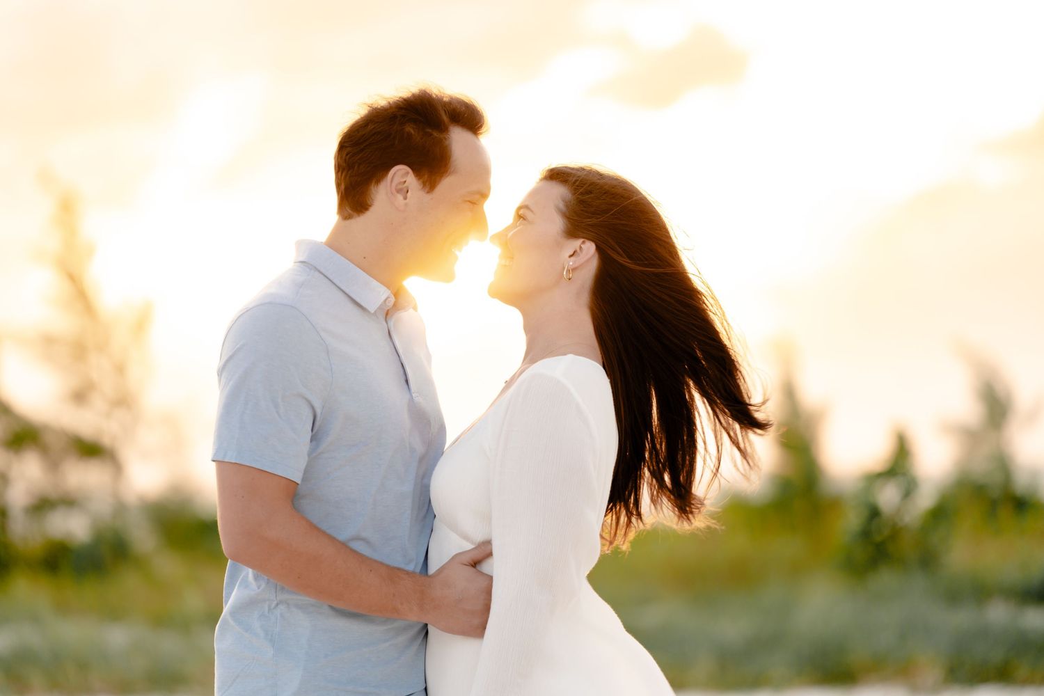 Romantic sunset portrait with soft lighting and tropical background.