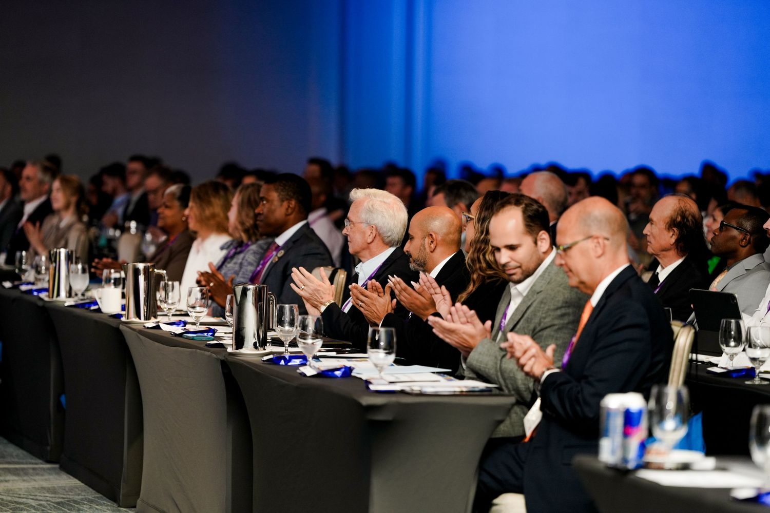 Business conference audience seated in rows at a formal presentation.
