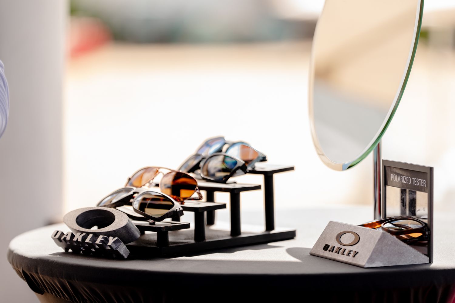 Close-up of hands working with eyewear on a white professional workspace.